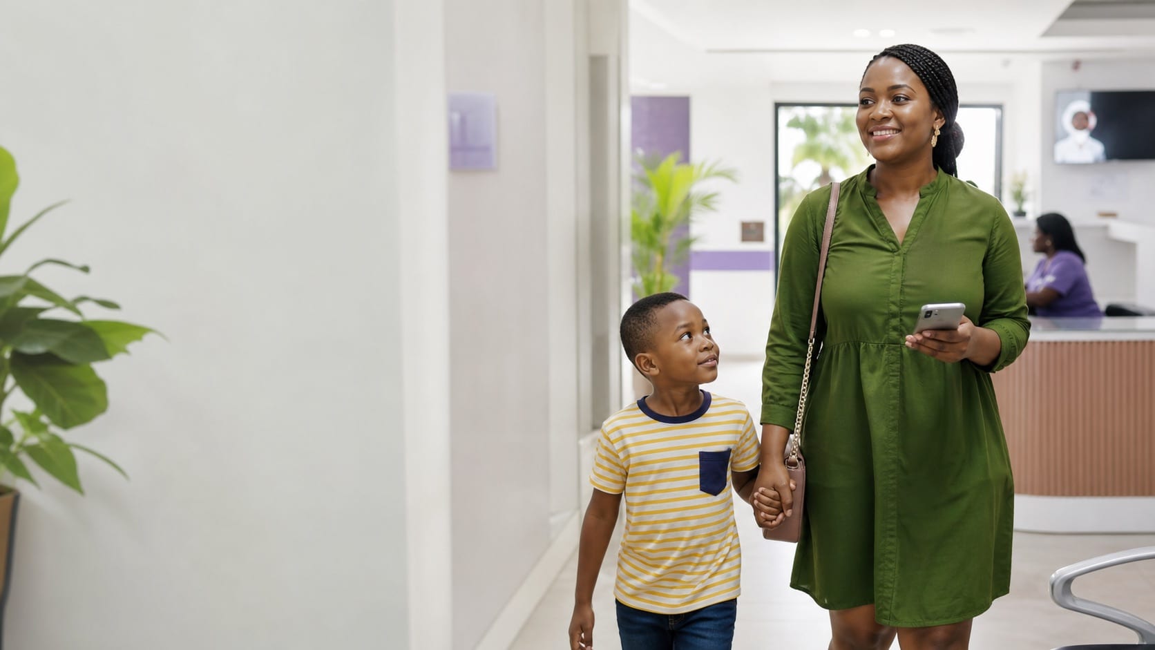 Mother and child walking through a clinic while checking health cover access