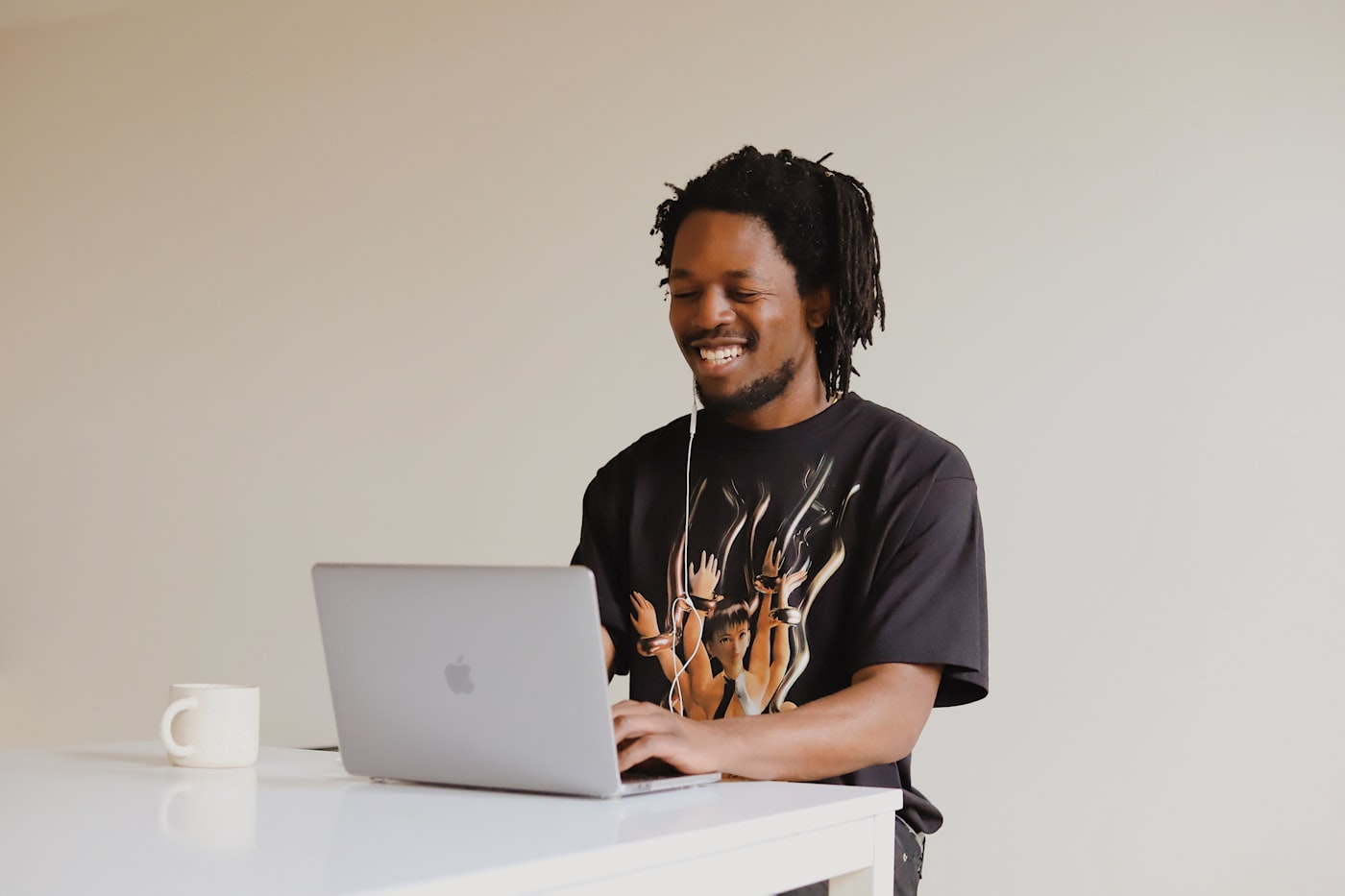 Black freelance professional working on a laptop from a clean home office